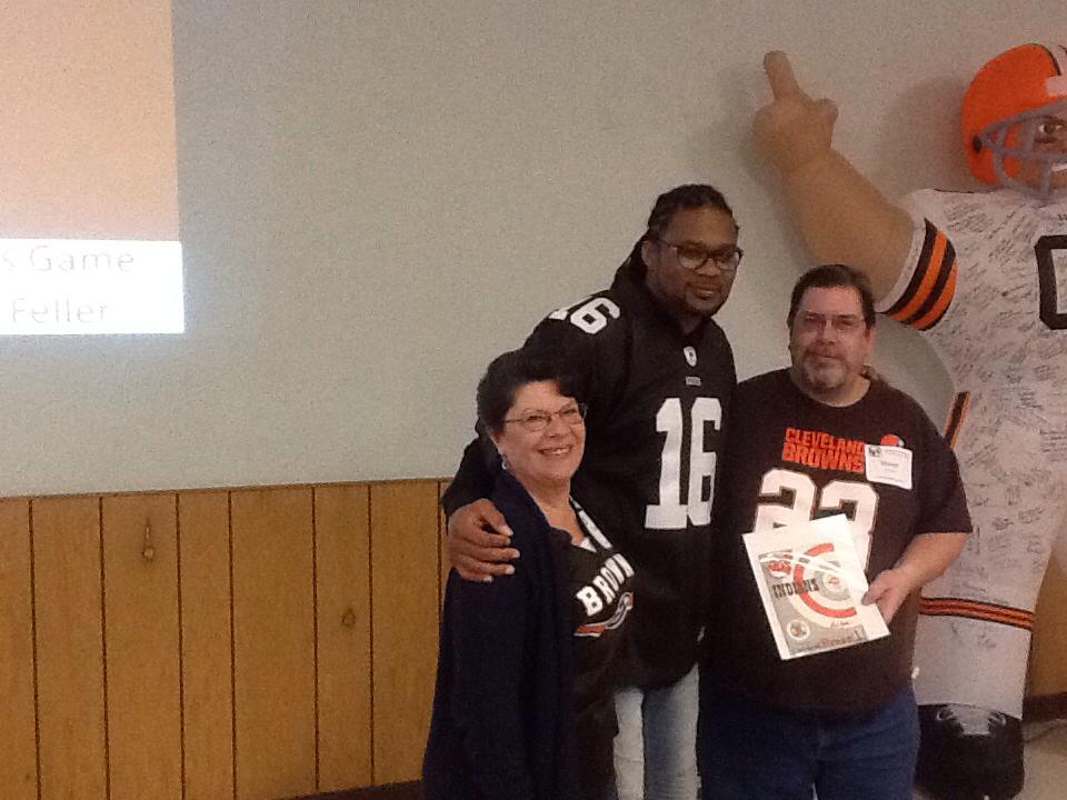My wife Donna and I with Josh Cribbs with the program after the winning bid